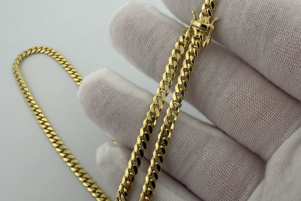 Close-up of 14K gold Cuban link chain clasp - Ott Family Jewelry authenticity guide